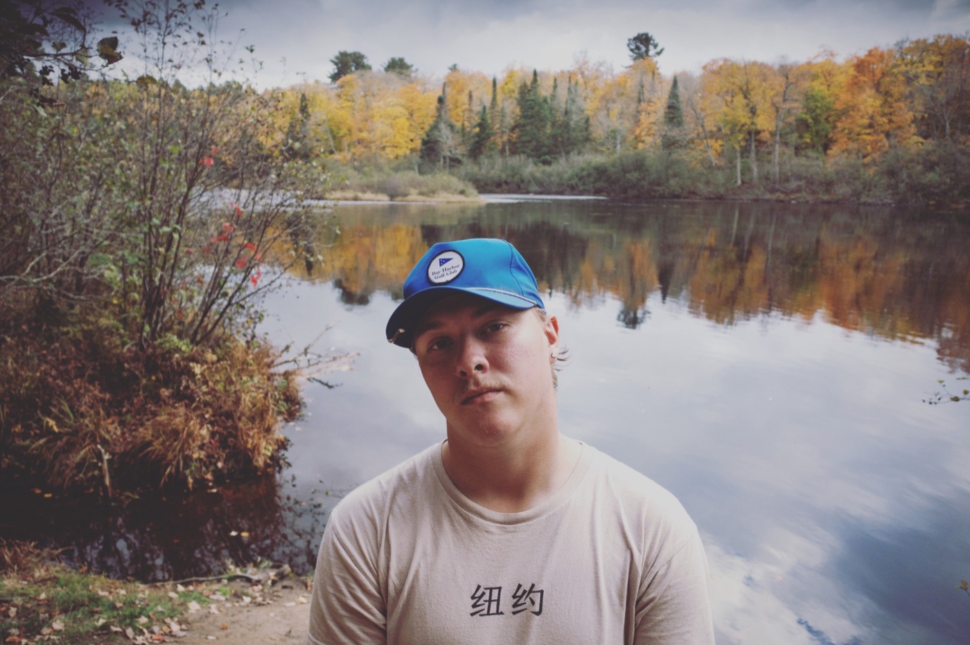 Dameon Spencer by a lake with fall colors in northern Michigan