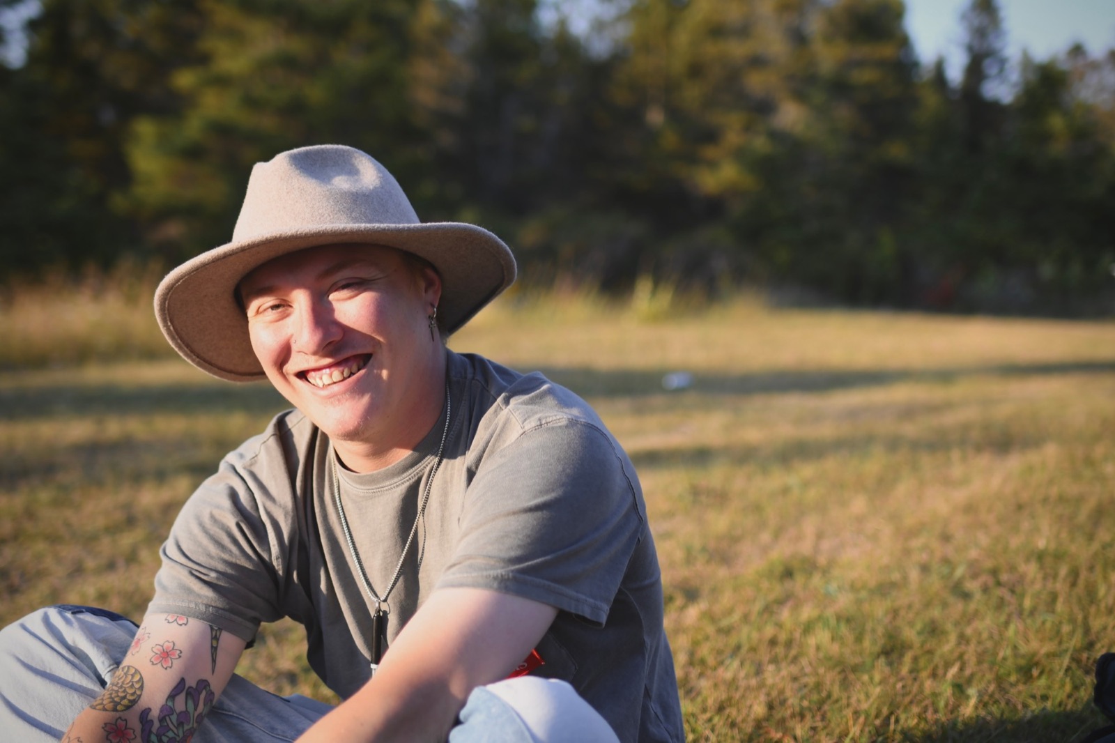 Dameon Spencer smiling outdoors in a field in Michigan